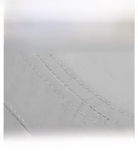 Detail of gray fabric texture with reinforced double-line stitching on flat top cap