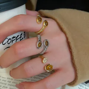 Vintage oval tiger eye stone rings with gold and silver bands and micro-set diamonds