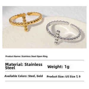 Detailed view of beaded stainless steel cross ring in gold and silver finishes