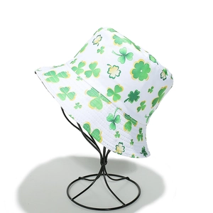Detail of St. Patrick's Day bucket hat with green shamrock pattern on white canvas fabric