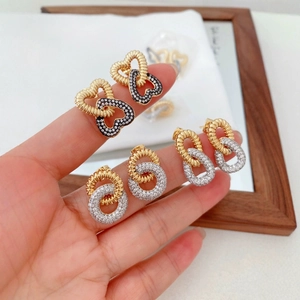 Three pairs of elegant gold and silver double-layered earrings with pavé zircon stones