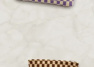 Detailed close-up of checkerboard knitted fabric texture and zipper closure on travel bags