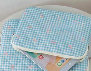 Blue and white checkered quilted laptop sleeve with pink bow pattern and silver zipper