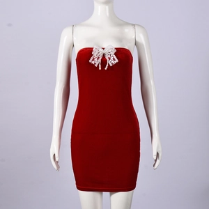Detail of red velvet mini dress featuring white lace bow and pearl pendant charm