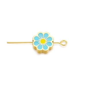 Macro shot of sky blue enamel cherry blossom flower spacer bead on golden jewelry needle