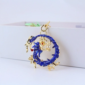 Blue enamel Chinese dragon keychain with gold metal frame and pearl in mouth on white background