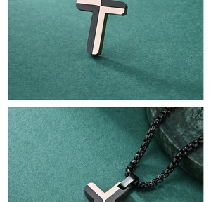 Macro view of dual-tone cross pendant with black and rose gold stainless steel layers