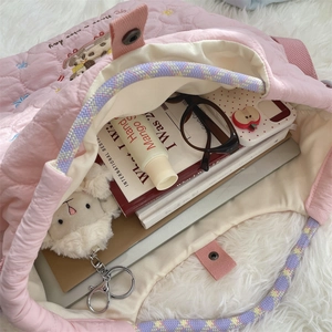 Detail view of large capacity pink quilted tote bag showing spacious interior storage