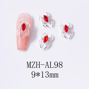 Macro detail of 9x13mm silver spider nail art charm with a vibrant red marquise stone