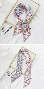Detail of floral long silk ribbon showing texture and 100% polyester wash label