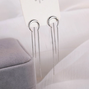 Orecchini a mezzaluna d'argento con lunghe catene a nappe su espositore bianco