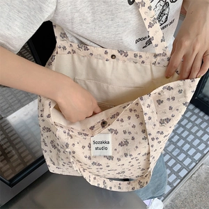 Close-up of floral canvas tote bag interior with magnetic buckle and zipper pocket