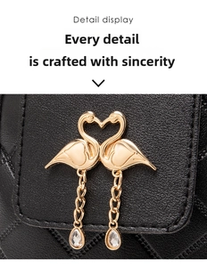Detailed view of black litchi pattern leather with golden flamingo metal pendant