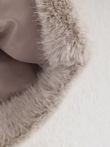 Detailed macro view of soft faux fur edge and smooth satin lining on this cropped jacket