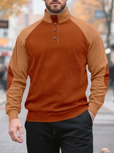 Detail of men's ribbed knit henley sweater with buttoned collar and elbow patches