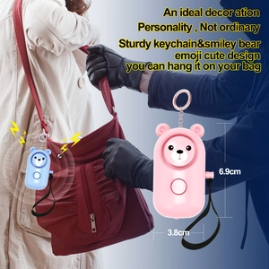 Detail view of bear-shaped personal alarm showing compact dimensions 6.9cm by 3.8cm