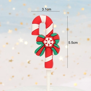 Detail of Christmas candy cane cake topper with green bow showing 5.5cm height dimension