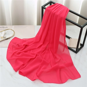 Detail of rose red pearl chiffon scarf showing lightweight texture and elegant drape