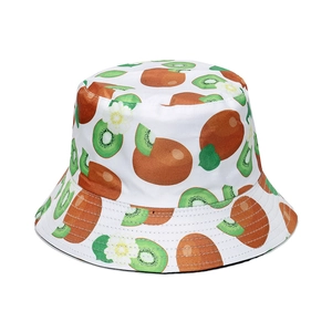 Detail of white bucket hat featuring all-over kiwi fruit pattern and green slices