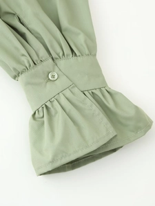 Close-up of sage green shirt ruffle cuffs with single button and fine stitching
