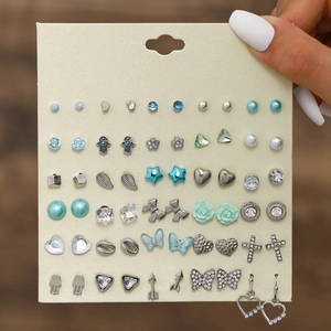 Detail of 20 pairs silver earring set with butterfly and heart studs on card