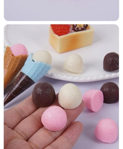Close-up of assorted 2cm miniature resin ice cream scoops and chocolate balls for DIY decor