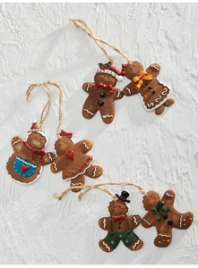 Detailed close-up of six unique resin gingerbread man ornaments for Christmas tree decor