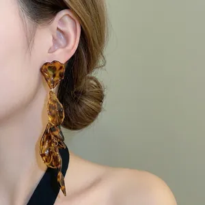 Elegant long leopard print resin petal drop earrings on a model in vintage style