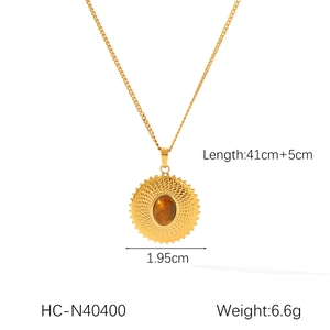Detail of round tiger eye stone pendant on golden chain with 41cm plus 5cm length spec