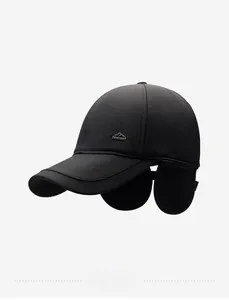 Detailed view of winter baseball cap with earflaps and mountain metal emblem