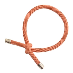 Elastic coral woven hair tie with polished silver metal buckles on white background