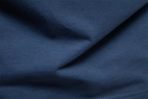 Macro shot of navy blue knitted fabric texture with soft ribbed details and fine weave