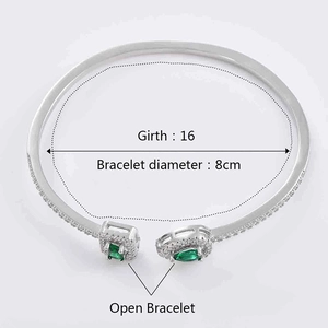 Detail view of adjustable silver open bracelet with green stones and dimensions