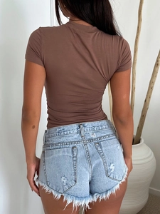 Rear view of slim fit brown Y2K short sleeve t-shirt and frayed light blue denim shorts
