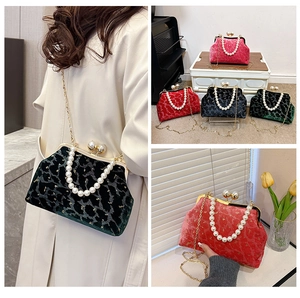 Detailed views of velvet shell bags in four colors with pearl handles and chain straps