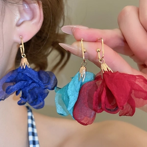 Detail of chiffon flower earrings in navy blue, teal, and red with gold hooks