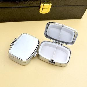 Portable silver metal pill box with two compartments shown in open and closed views