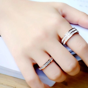 Rose gold titanium steel ring with sparkling zircon stones worn on hand elegantly