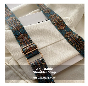Detail of adjustable vintage ethnic style shoulder strap with bronze metal buckle
