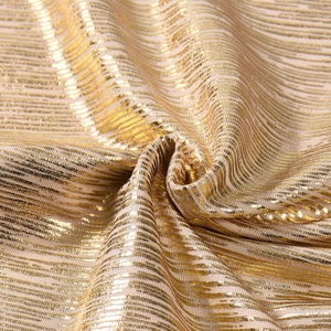 Detailed macro view of the golden metallic fabric texture with elegant pleated stripe pattern