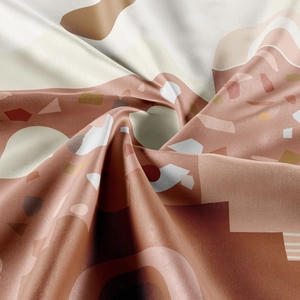 Macro shot of abstract geometric tapestry fabric showing twill texture and warm earth tones