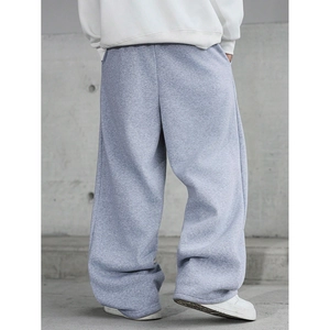 Back view of grey baggy sweatpants on model showing loose fit and fabric drape detail