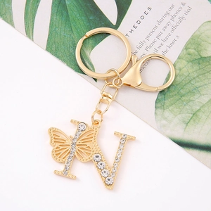 Detail of crystal butterfly gold letter N keychain with sparkling rhinestones and metal ring