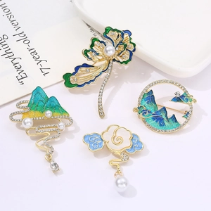 Chinese style enamel gourd brooch set with pearls and crystals on a white plate