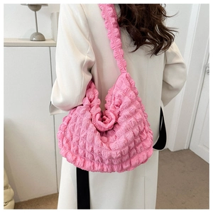 Detail of pink bubble texture hobo bag showing pleated fabric and wide shoulder strap