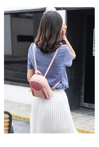 Pink mini sequin backpack for women shown in an outdoor lifestyle setting with model