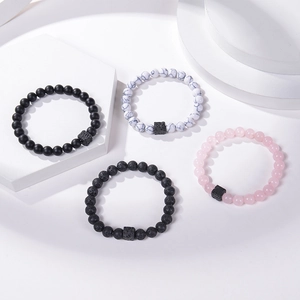 Natural lava rock and turquoise beaded stretch bracelets displayed on white geometric steps