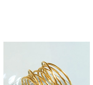 Macro shot of the twisted golden spiral links from the chain necklace and bracelet set