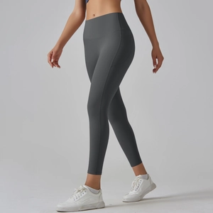 Detail view of high-waisted dark grey yoga leggings with side pockets and seamless fabric