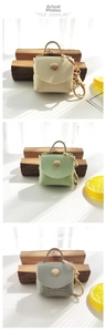 Three mini PU leather coin purse keychains in cream, mint green, and blue with wave stitching